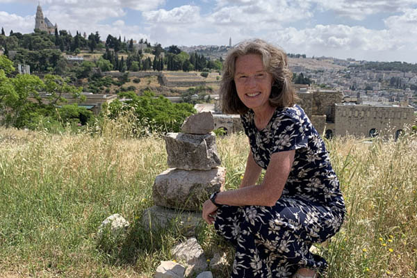 Kristyn Allred squatting down on hill in Jerusalem