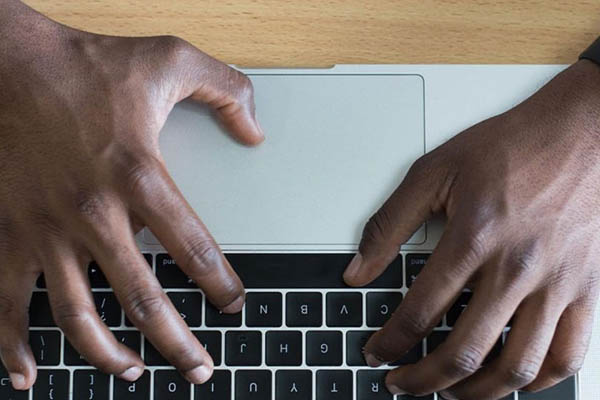 hands on keyboard of laptop
