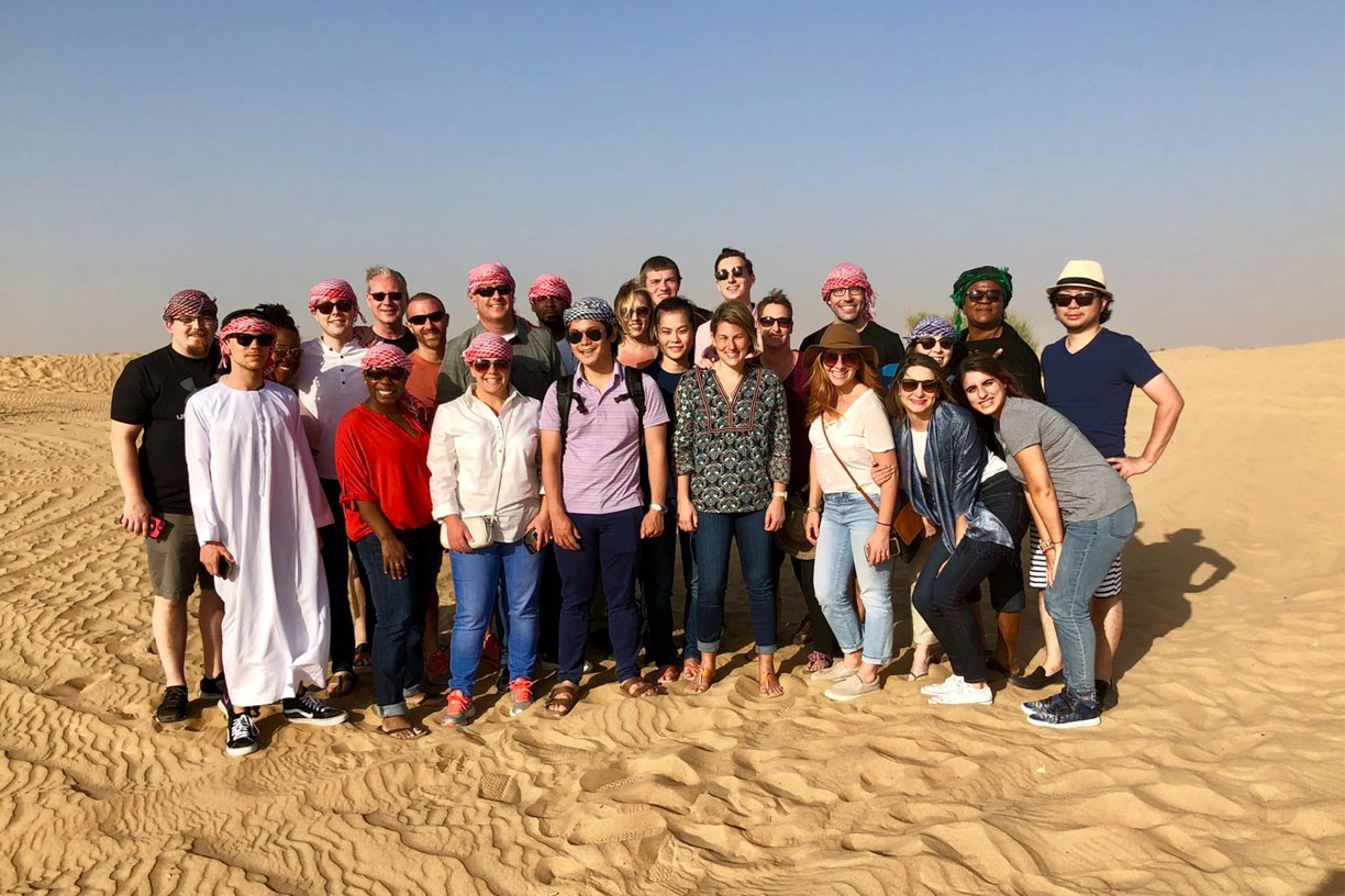 Students posing as a group in bahrain desert