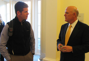 Daniel F. Akerson, right, listens to second year MBA student John Evans.