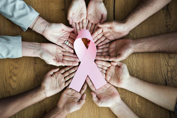 Hands holding breast cancer ribbon