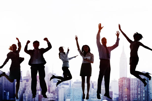 Business people jumping in the air with city background