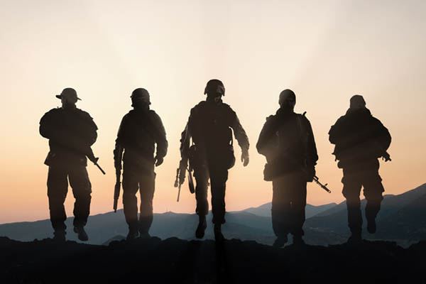Five military members at sunset