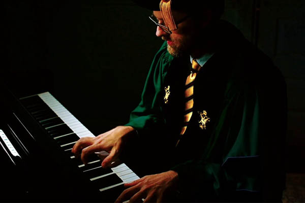 Professor Aaron Koehl playing keyboard